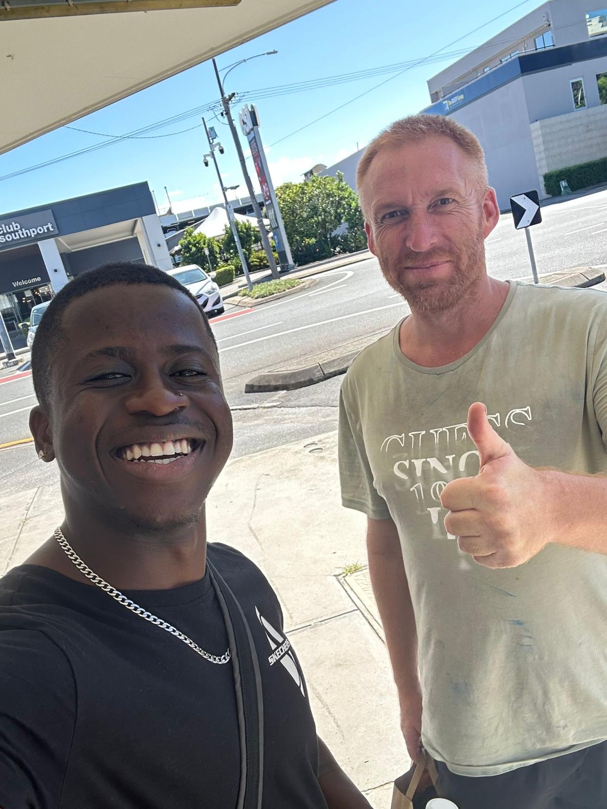 Support worker and participant smiling outdoors at Southport