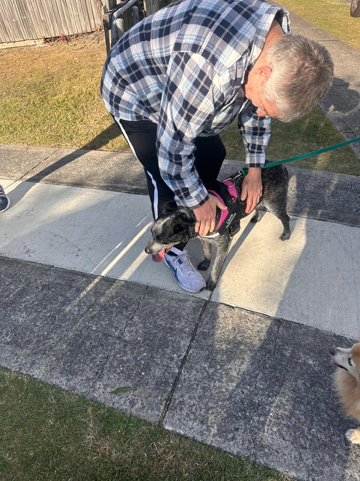 Participant with their support dog on a sunny walk