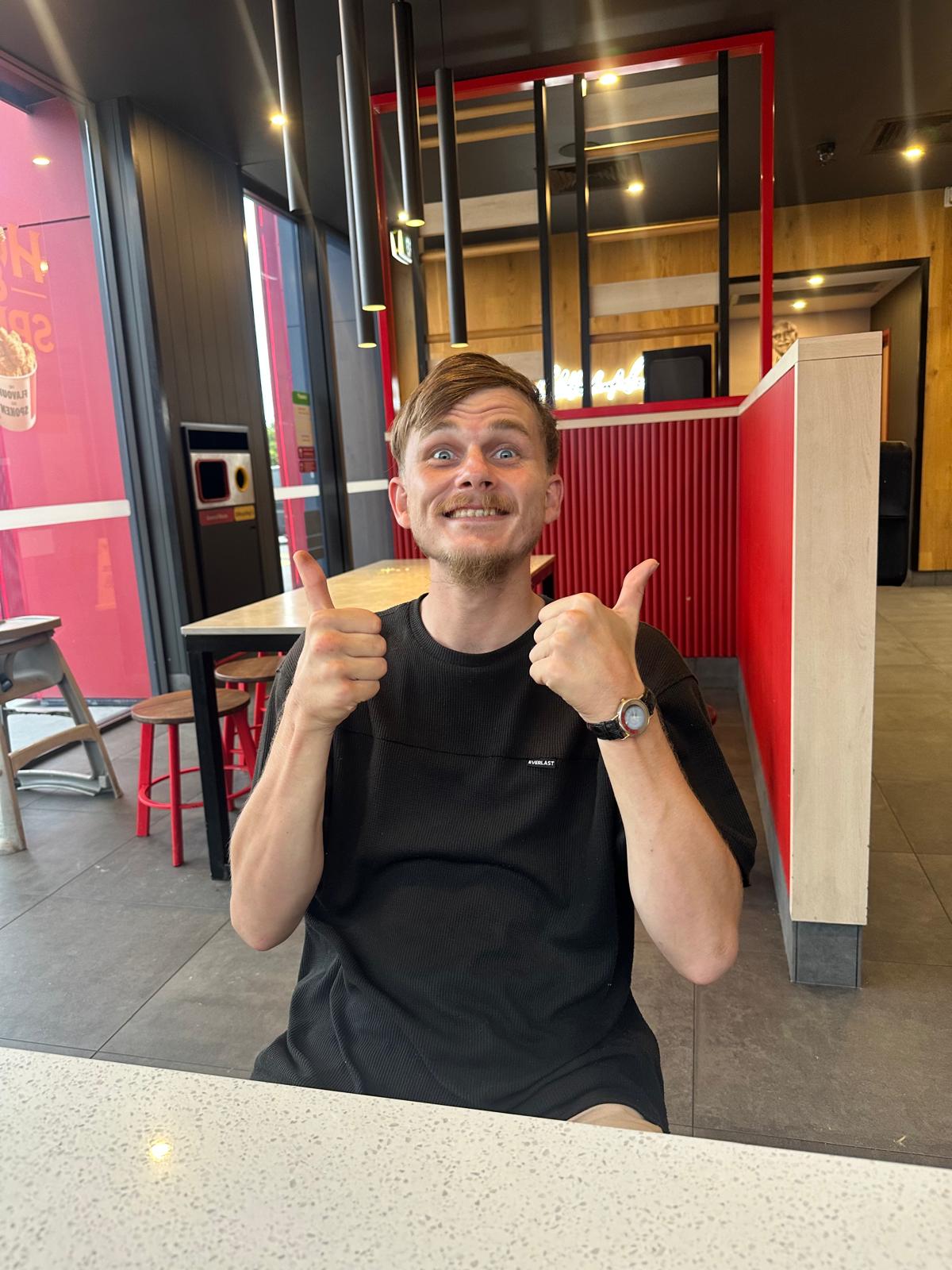 Participant giving thumbs up at a meal out
